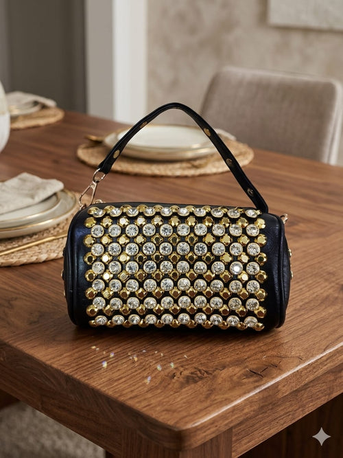 Crystal rhinestone barrel bag held by hand in library setting