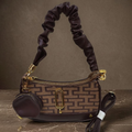 Marc Jacobs Snapshot hobo bag brown monogram on dark marble surface