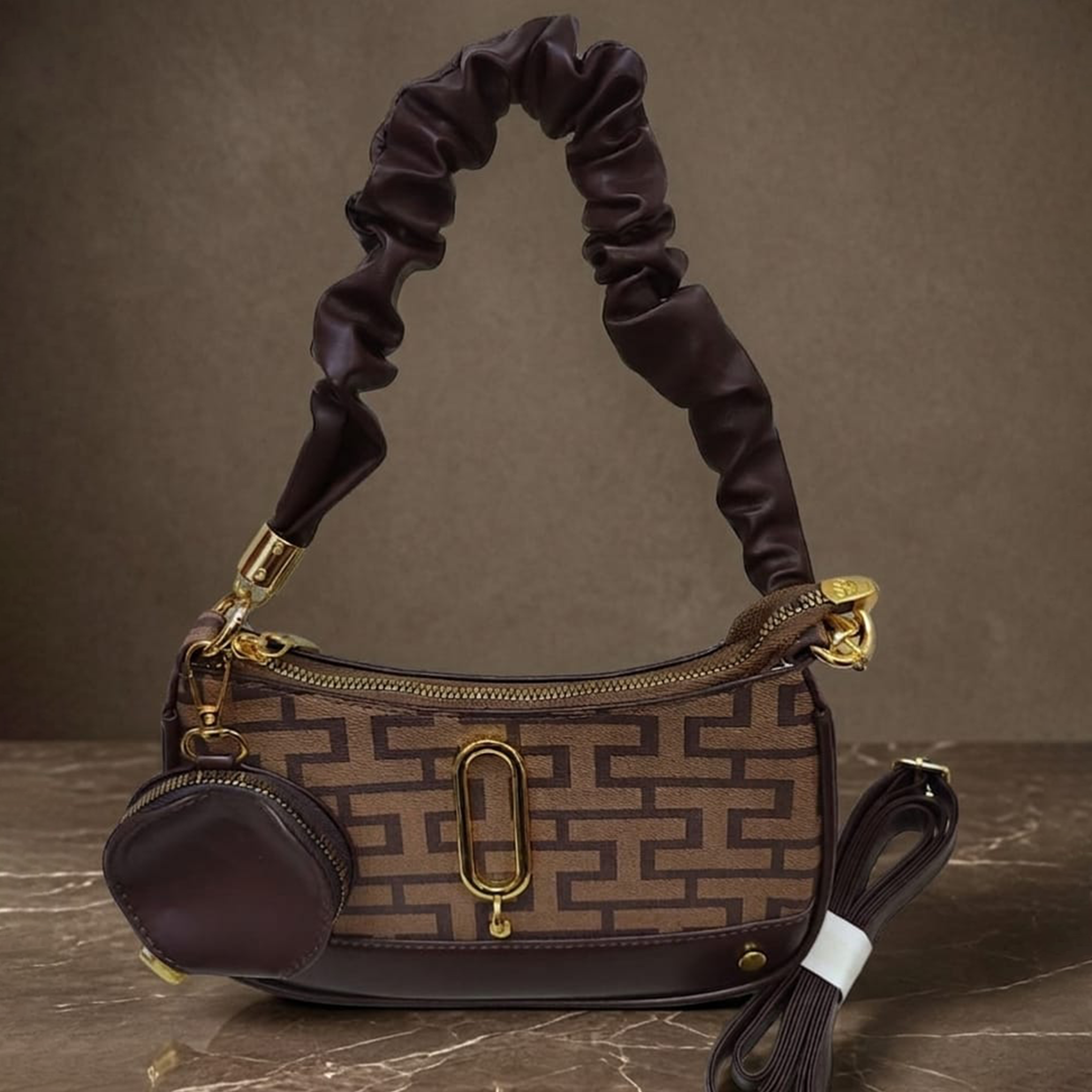 Marc Jacobs Snapshot hobo bag brown monogram on dark marble surface