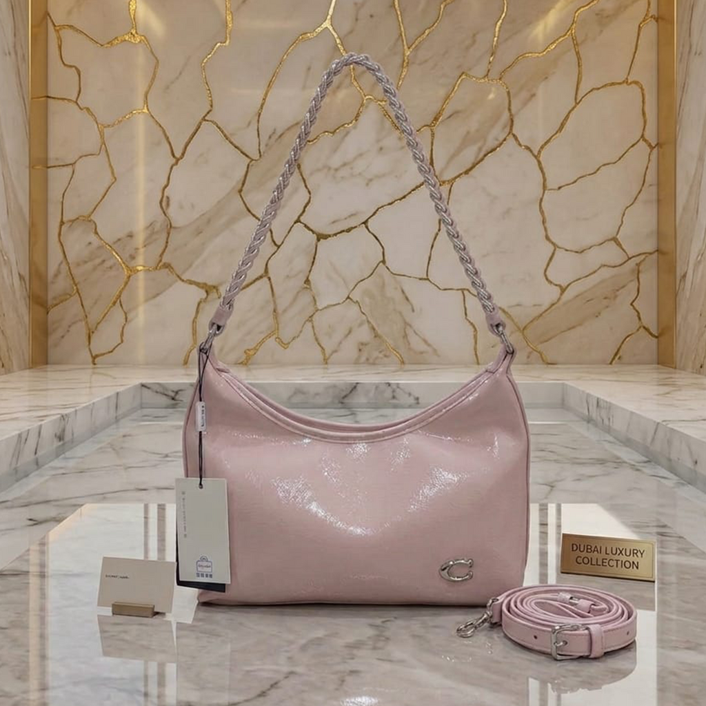 Coach Cassy hobo bag petal pink on marble steps against gold veined marble wall