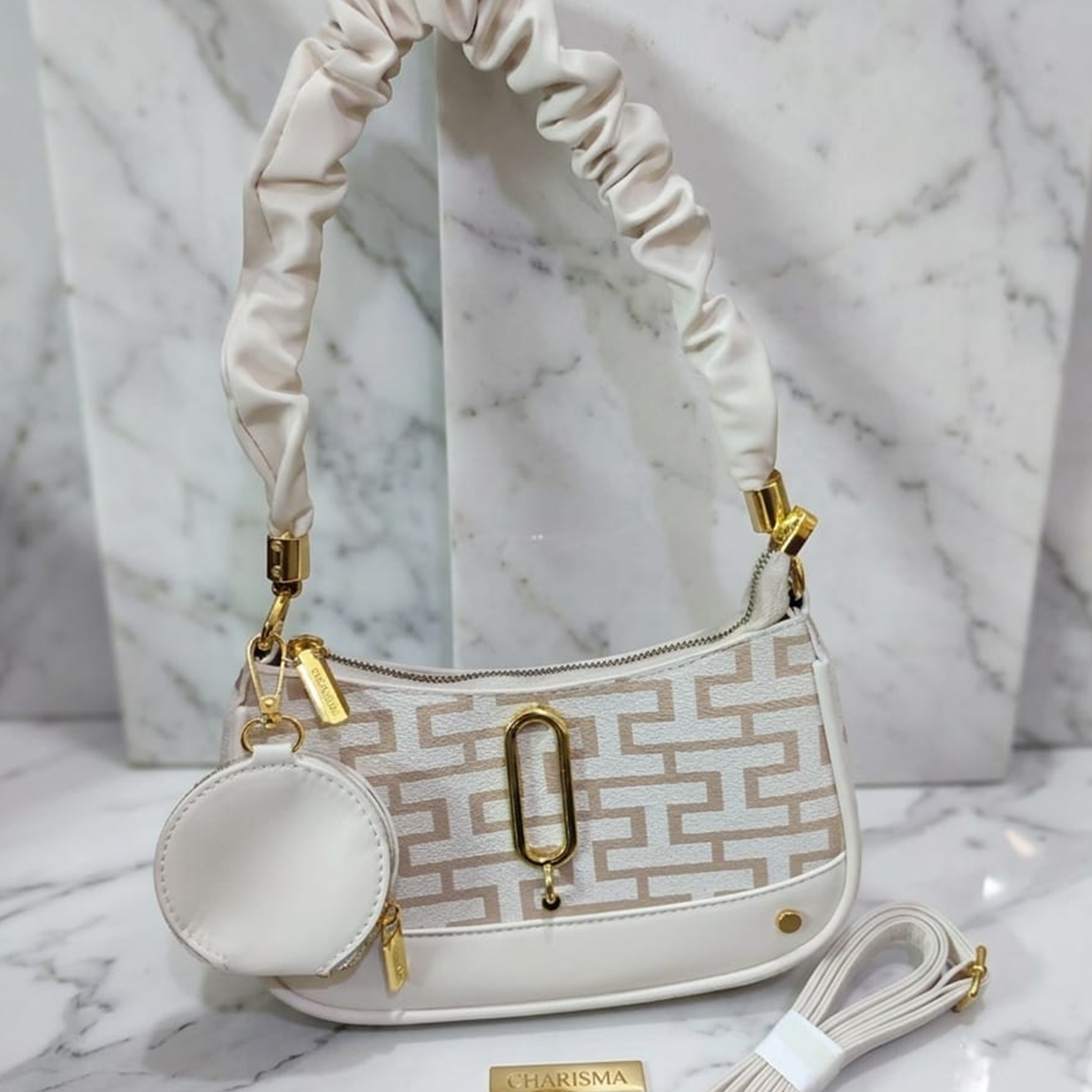 Marc Jacobs Snapshot hobo bag ivory monogram on marble surface with Charisma tag
