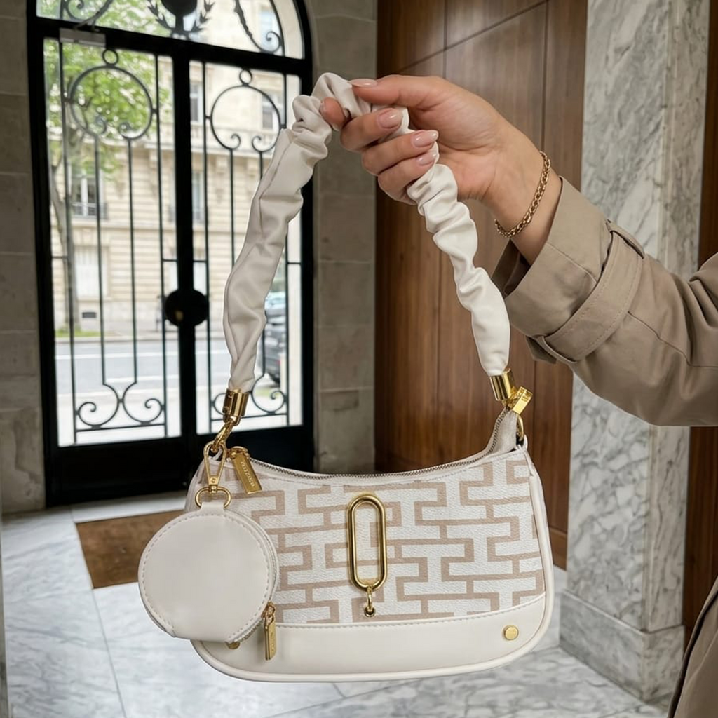 Marc Jacobs Snapshot hobo bag ivory monogram held outside Parisian building