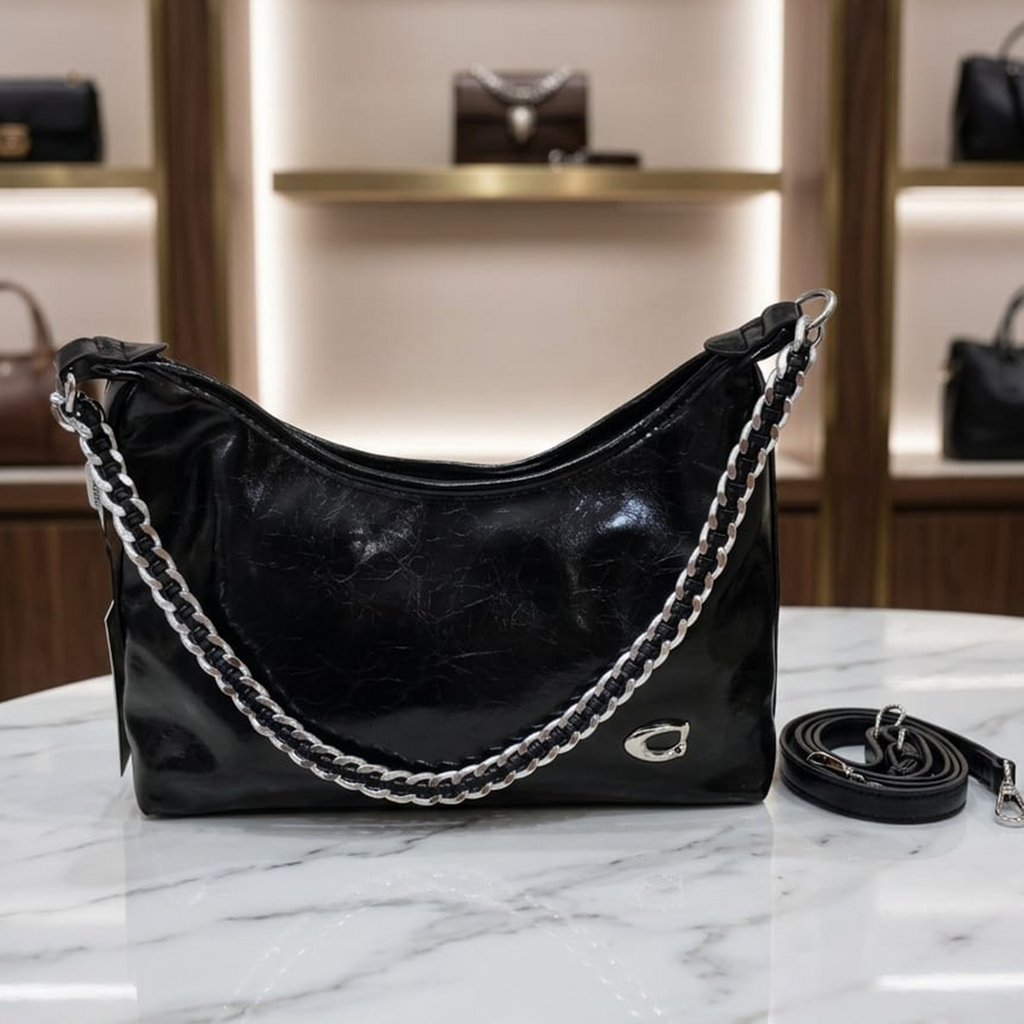 Coach Soft Tabby shoulder bag black on marble table in luxury boutique