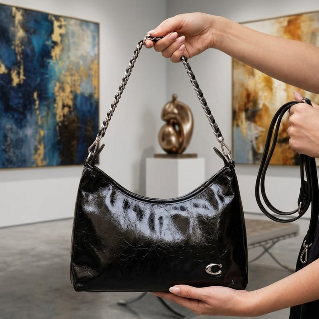 Coach Soft Tabby shoulder bag black held up in art gallery