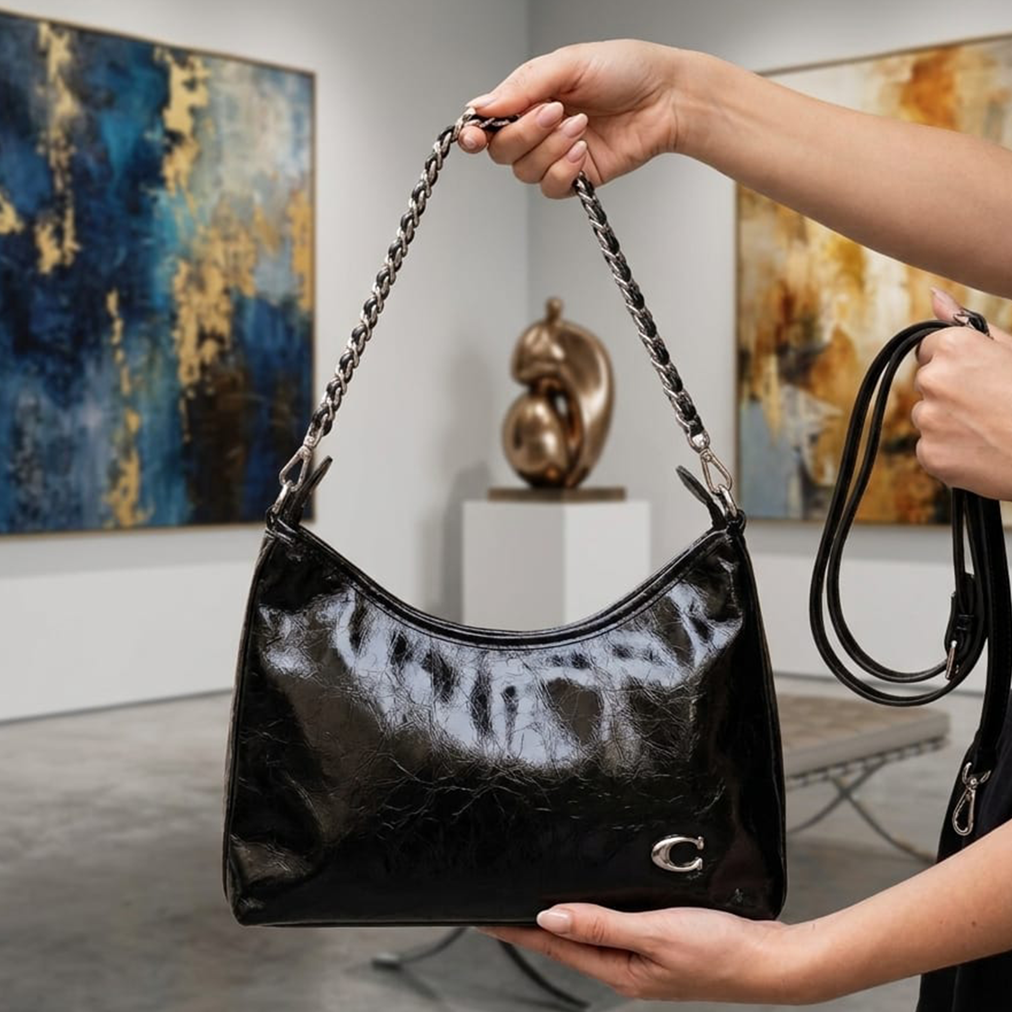 Coach Soft Tabby shoulder bag black held up in art gallery