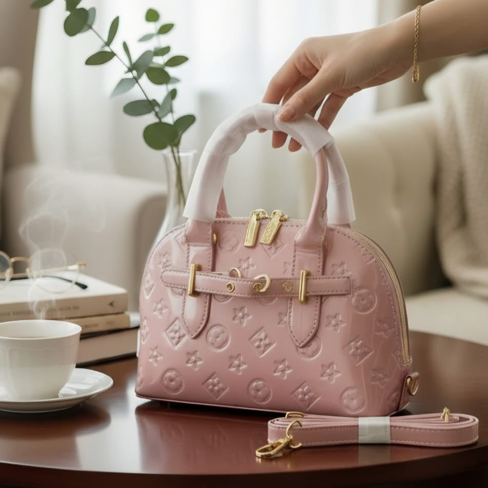 Louis Vuitton Speedy Bandoulière rose pink monogram empreinte on wooden table in luxury living room with crossbody strap