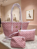 Monogram Signature 3-Piece Tote Set in blush pink displayed in boutique